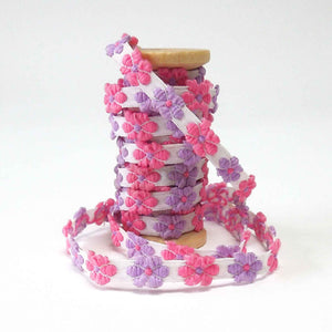 Pretty trims wrapped around various different wooden bobbins for lovely gifts.